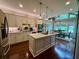 Open-concept kitchen with a large center island, modern appliances, and dining area with backyard views at 3532 W Hampton Nw Dr, Marietta, GA 30064