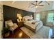 Spacious main bedroom with dark accent wall, tray ceiling, neutral furniture, and abundant natural light at 3532 W Hampton Nw Dr, Marietta, GA 30064