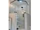 Modern shower featuring white marble tile, glass doors, and matte black fixtures at 3532 W Hampton Nw Dr, Marietta, GA 30064