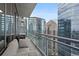 Spacious balcony with glass railings offering panoramic city views from a high-rise building at 1065 Peachtree Ne St # 3505, Atlanta, GA 30309