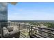 Balcony view showcasing the city skyline and lush greenery on a clear day, and outdoor seating at 1065 Peachtree Ne St # 3505, Atlanta, GA 30309