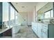 Stylish bathroom with soaking tub, glass shower, city views, double vanity, and modern finishes at 1065 Peachtree Ne St # 3505, Atlanta, GA 30309