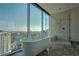 Bright bathroom featuring a soaking tub with stunning city view, glass shower, and marble floors at 1065 Peachtree Ne St # 3505, Atlanta, GA 30309