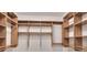 Spacious walk-in closet with custom wood shelving and ample storage space at 1065 Peachtree Ne St # 3505, Atlanta, GA 30309