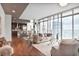 Bright living room with floor-to-ceiling windows and open concept kitchen and dining area at 1065 Peachtree Ne St # 3505, Atlanta, GA 30309