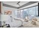 Comfortable main bedroom with expansive windows offering city views, neutral colors, and a ceiling fan at 1065 Peachtree Ne St # 3505, Atlanta, GA 30309