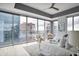 Bright main bedroom with panoramic city views through large windows, a ceiling fan, and comfortable seating at 1065 Peachtree Ne St # 3505, Atlanta, GA 30309