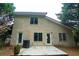 Back exterior offers patio, door, and windows at 128 Garden Walk, Stockbridge, GA 30281