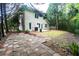 View of the backyard featuring a stone paver patio and a well-maintained lawn, perfect for outdoor gatherings at 128 Garden Walk, Stockbridge, GA 30281