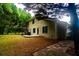Spacious backyard featuring a stone-paved walkway, well-maintained lawn, and lush, mature trees at 128 Garden Walk, Stockbridge, GA 30281