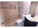 Modern bathroom features a tiled shower, sleek vanity, and contemporary fixtures at 128 Garden Walk, Stockbridge, GA 30281