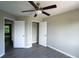 Neutral bedroom offers vinyl floors, ceiling fan, and closet at 128 Garden Walk, Stockbridge, GA 30281