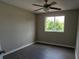 Neutral bedroom offers vinyl floors, natural light, and ceiling fan at 128 Garden Walk, Stockbridge, GA 30281