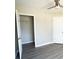 Neutral bedroom offers vinyl floors, closet, and ceiling fan at 128 Garden Walk, Stockbridge, GA 30281