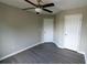 Neutral bedroom offers vinyl floors and ceiling fan at 128 Garden Walk, Stockbridge, GA 30281