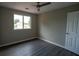 Neutral bedroom offers vinyl floors, natural light, and ceiling fan at 128 Garden Walk, Stockbridge, GA 30281