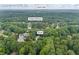 Aerial view of a home with a large backyard surrounded by lush greenery, including a view of Ozora Lake at 2990 Cove Crossing Dr, Lawrenceville, GA 30045