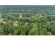 Stunning aerial view of a wooded neighborhood with a serene lake at 2990 Cove Crossing Dr, Lawrenceville, GA 30045