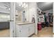 Charming bathroom with a granite-topped vanity, leads to a generously sized walk-in closet, blending functionality and style at 2990 Cove Crossing Dr, Lawrenceville, GA 30045