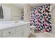 Bright bathroom featuring white vanity, geometric shower curtain and neutral flooring at 2990 Cove Crossing Dr, Lawrenceville, GA 30045