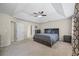 Spacious bedroom with en suite access, tray ceiling and fan, plus lots of natural light at 2990 Cove Crossing Dr, Lawrenceville, GA 30045