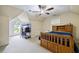 Spacious bedroom with a ceiling fan, a large window, and space for a desk creating a functional and bright atmosphere at 2990 Cove Crossing Dr, Lawrenceville, GA 30045