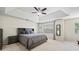 Comfortable bedroom featuring a tray ceiling, ceiling fan, bedside tables, and windows, offering natural light at 2990 Cove Crossing Dr, Lawrenceville, GA 30045