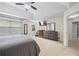 Neutral bedroom features a tray ceiling, fan, dresser, and windows for lots of natural light at 2990 Cove Crossing Dr, Lawrenceville, GA 30045