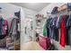 Large walk-in closet with ample shelving and storage solutions, offers a seamless transition to the connected bathroom at 2990 Cove Crossing Dr, Lawrenceville, GA 30045