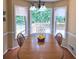 Bright dining area with backyard views through large windows, a cozy spot for Gathering meals at 2990 Cove Crossing Dr, Lawrenceville, GA 30045
