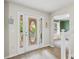 Bright foyer featuring new floors and a decorative door, showcasing a glimpse into the dining and living spaces at 2990 Cove Crossing Dr, Lawrenceville, GA 30045
