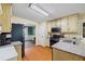 This kitchen features stainless steel appliances, wooden floors, and granite countertops at 2990 Cove Crossing Dr, Lawrenceville, GA 30045