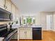 Bright kitchen features granite counters, modern appliances, and a breakfast nook overlooking the backyard at 2990 Cove Crossing Dr, Lawrenceville, GA 30045