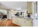 Cozy kitchen includes stainless steel appliances, wooden floors, and granite countertops, with a view of the living room at 2990 Cove Crossing Dr, Lawrenceville, GA 30045