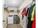 Functional laundry room featuring modern washer and dryer units, storage shelves, and ample space for sorting and folding at 2990 Cove Crossing Dr, Lawrenceville, GA 30045