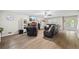 Open living room with fireplace, modern furniture, and lots of natural light at 2990 Cove Crossing Dr, Lawrenceville, GA 30045