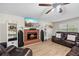 Cozy living room with a brick fireplace, comfortable leather seating, and modern media setup for entertainment at 2990 Cove Crossing Dr, Lawrenceville, GA 30045