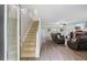 Comfortable living room featuring new floors, a staircase, and relaxed seating area with a fireplace at 2990 Cove Crossing Dr, Lawrenceville, GA 30045