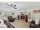 Spacious living room with a brick fireplace, comfortable seating, and bright windows, perfect for relaxing at 2990 Cove Crossing Dr, Lawrenceville, GA 30045