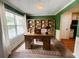 Brightly lit office space with a traditional wooden desk, shelving, and large windows with picturesque green views at 2990 Cove Crossing Dr, Lawrenceville, GA 30045