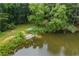 Picturesque pond with a small dock and lush greenery offering a tranquil waterfront setting at 2990 Cove Crossing Dr, Lawrenceville, GA 30045