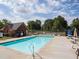 Community swimming pool with lounge chairs and tables, perfect for relaxing on warm days at 2990 Cove Crossing Dr, Lawrenceville, GA 30045