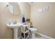 Powder room featuring pedestal sink, oval mirror, and neutral wall color at 2990 Cove Crossing Dr, Lawrenceville, GA 30045