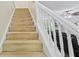 Carpeted staircase with white banister leads to the upper level, with a glimpse of the living room beyond at 2990 Cove Crossing Dr, Lawrenceville, GA 30045