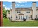 View of backyard with a covered patio area, a grill, and a sprawling lawn perfect for outdoor activities at 417 Red Coat Ln, Woodstock, GA 30188