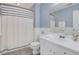 Bathroom featuring white vanity with sink, decorative curtain, and grey flooring at 417 Red Coat Ln, Woodstock, GA 30188