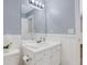 The bathroom features a vanity with sink, mirror, and light blue walls at 417 Red Coat Ln, Woodstock, GA 30188