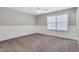 A bright bedroom features neutral walls, plush carpeting, and a ceiling fan for added comfort at 417 Red Coat Ln, Woodstock, GA 30188