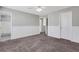 Neutral bedroom featuring baseboard, carpet, and view to attached bathroom and closet at 417 Red Coat Ln, Woodstock, GA 30188