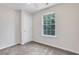 This cozy bedroom features neutral carpet, a ceiling fan, and a window that bathes the room in natural light at 417 Red Coat Ln, Woodstock, GA 30188